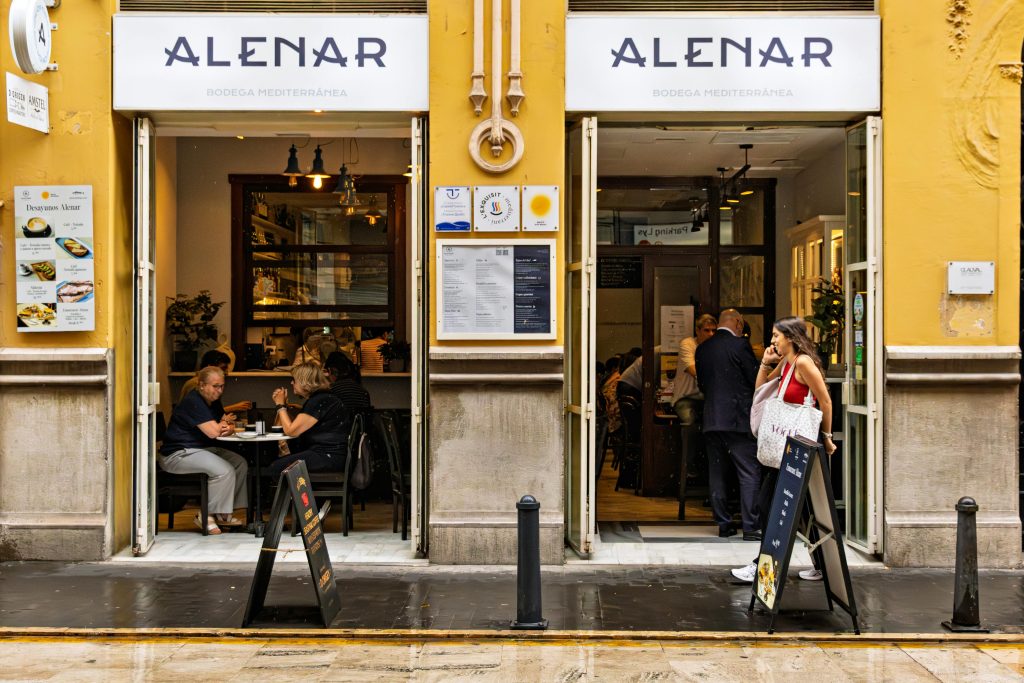Outdoor view of Alenar Mediterranean restaurant with patrons enjoying a meal.